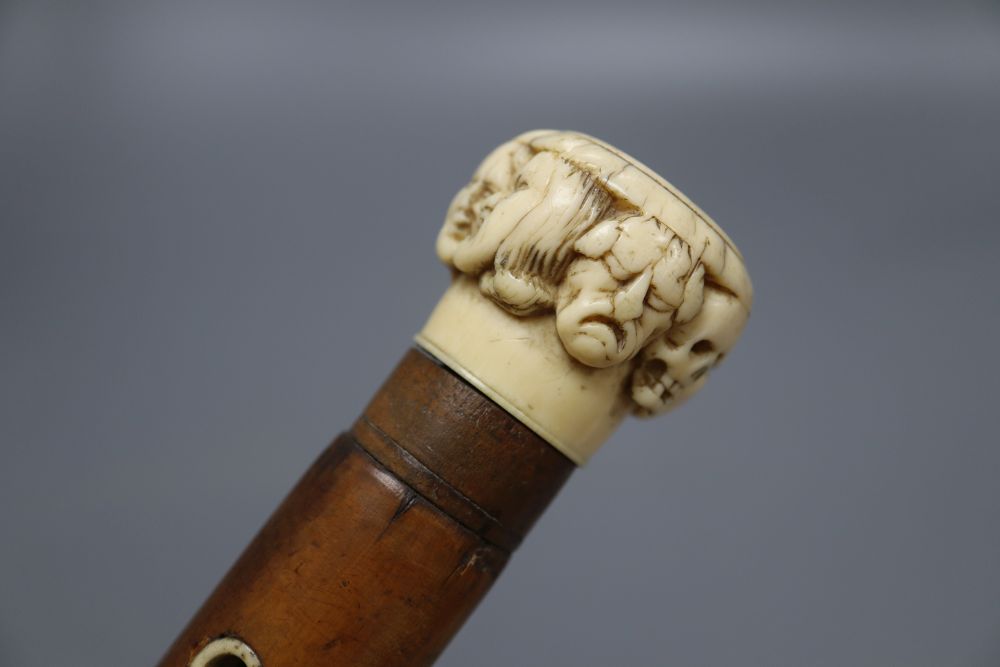 A late 19th century ivory mask handled walking cane, overall length 92cm